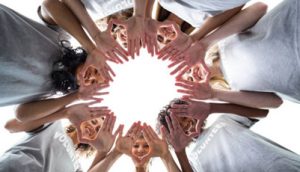 faces and hands in the shape of a wreath